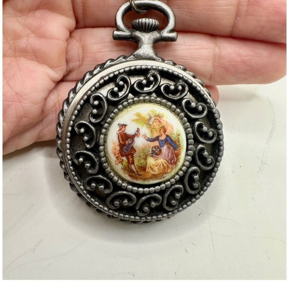 Long round  locket necklace with courtship scene